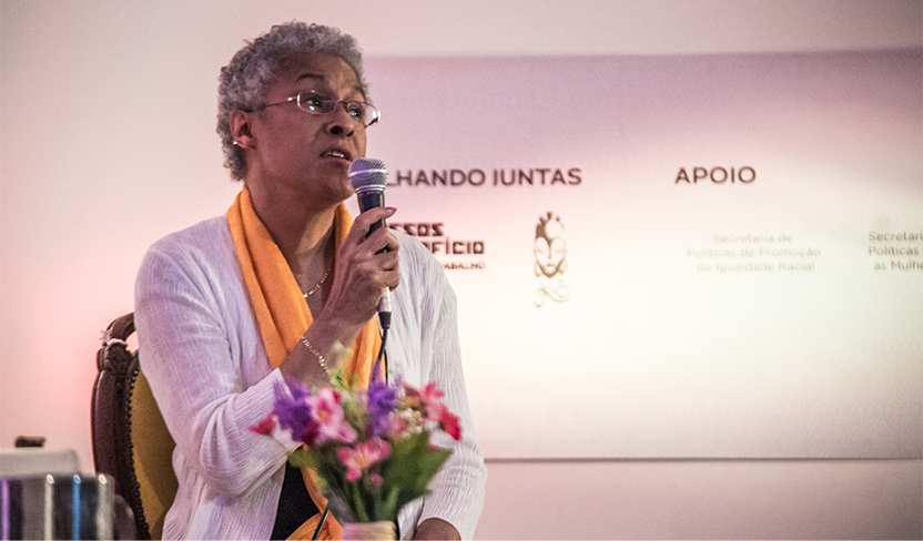 An image of Patricia Hill Collins speaking into a microphone.