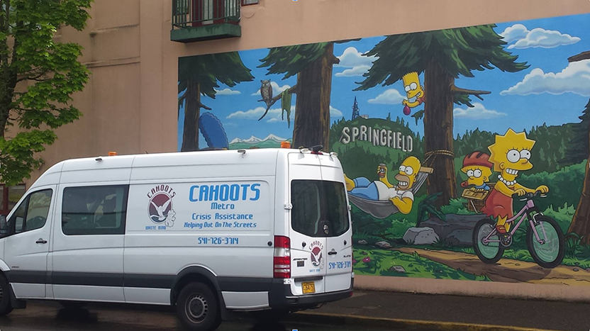 White van with CAHOOTS logo in front of a mural showing characters from The Simpsons cartoon