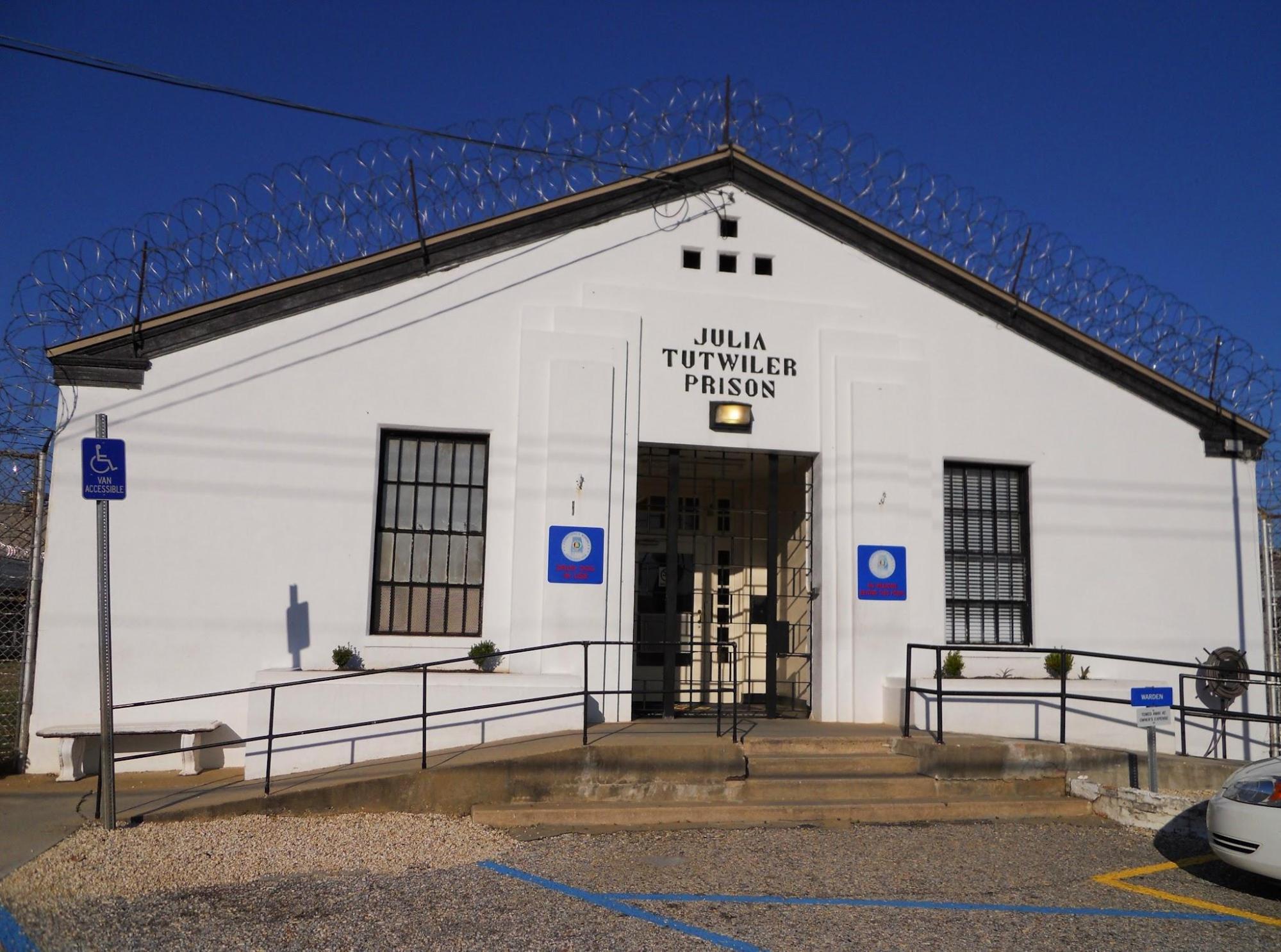 Photo of prison building with barbed wire on top