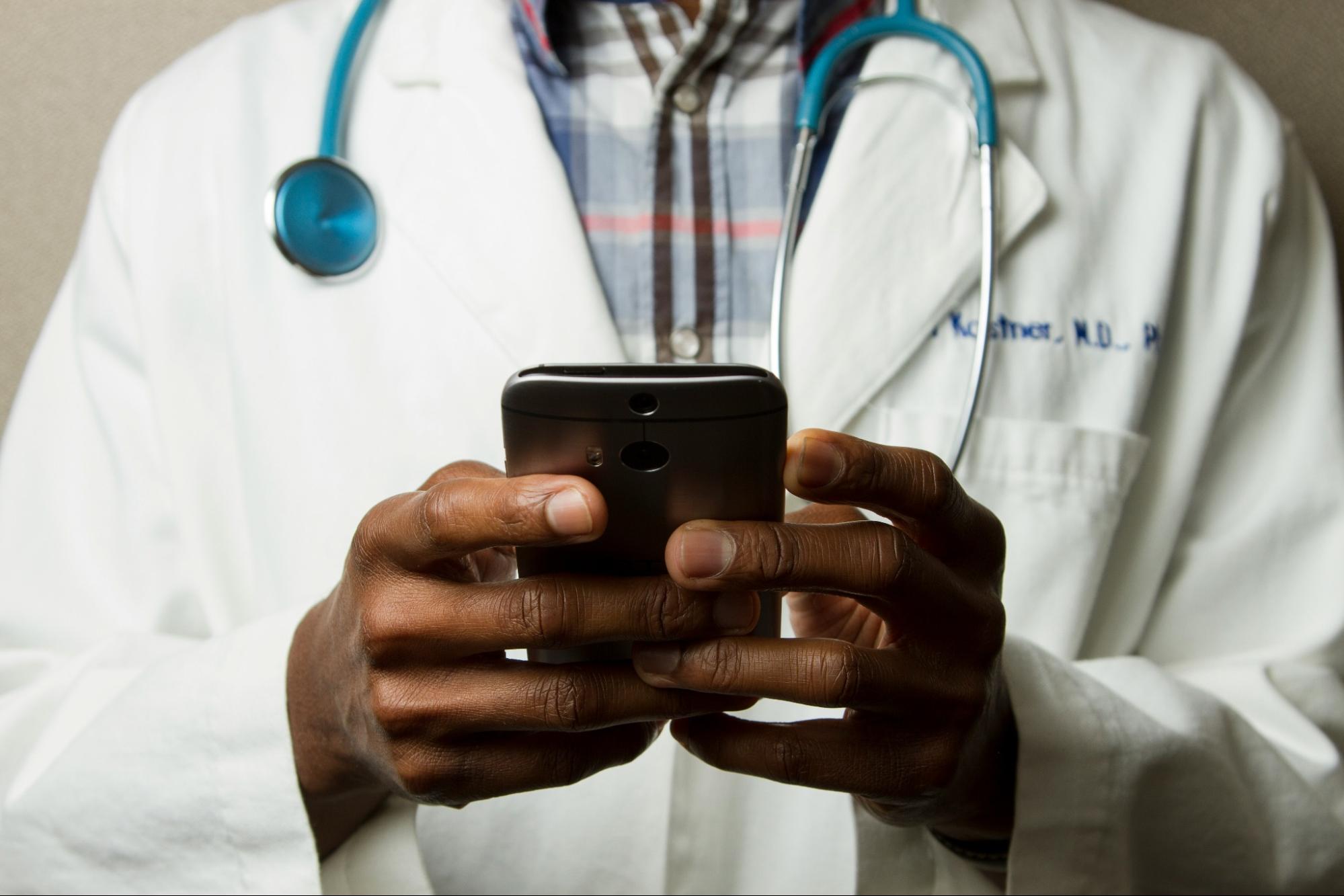 A doctor looking at their phone.