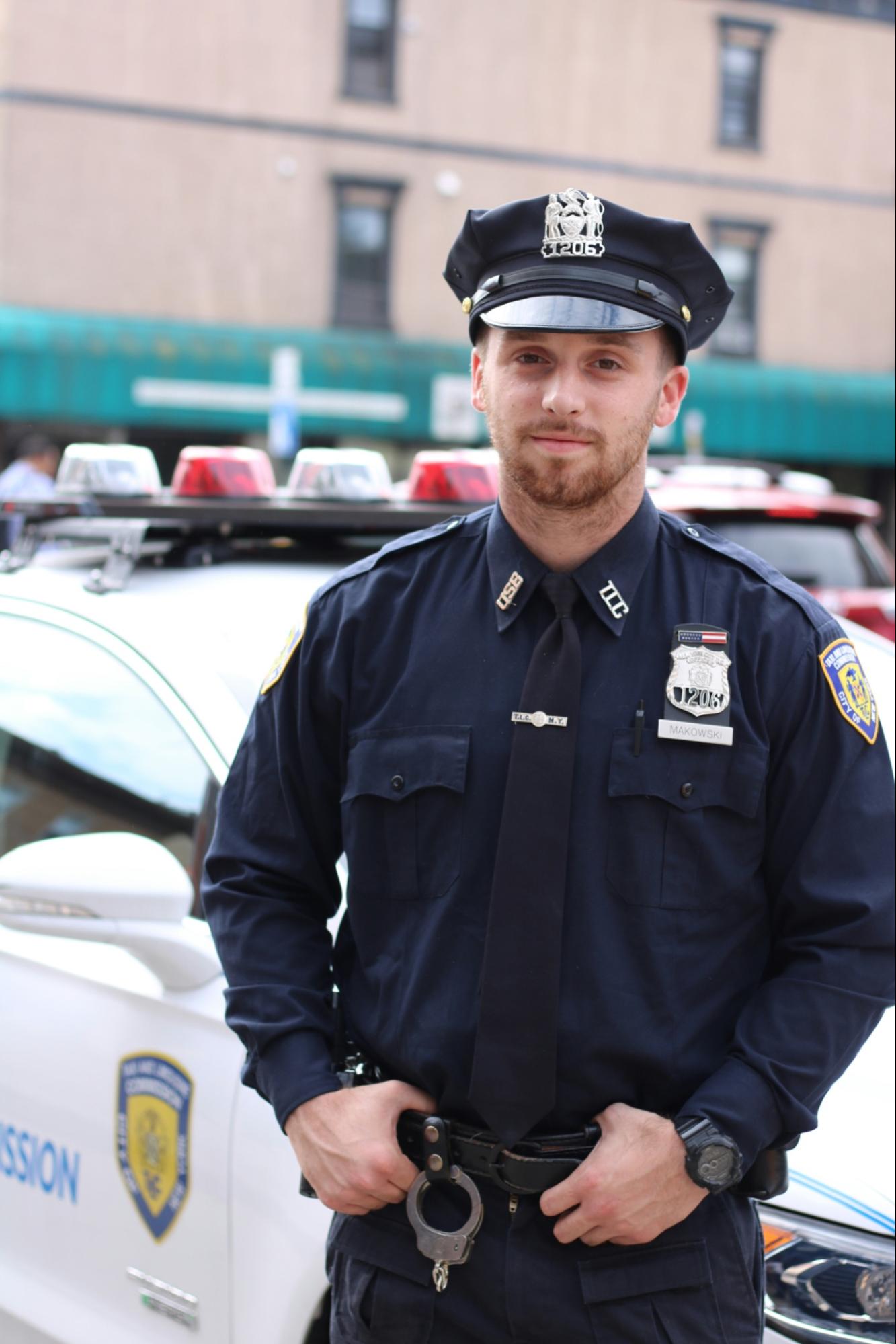 Police officer standing in front of a police car