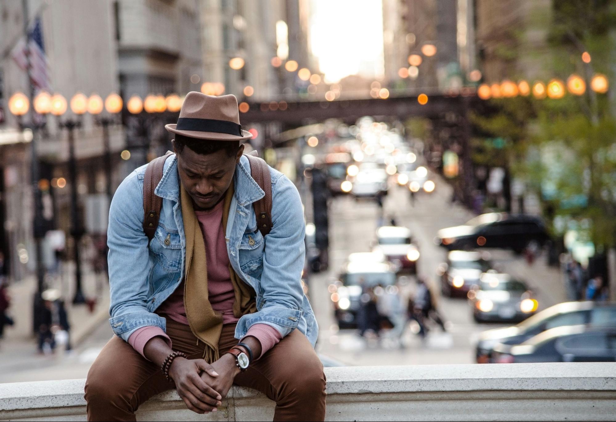 a contemplative man against a busy city backdrop.