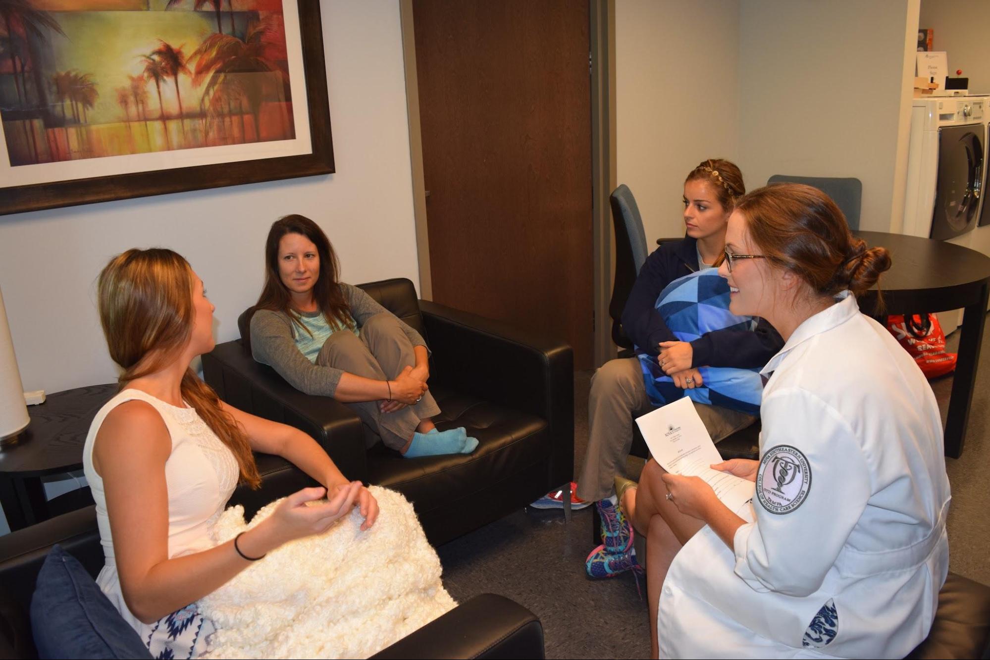 3 patients and a medical professional sitting in a group