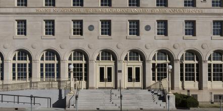 Front of a courthouse with ramps bypassing the stairs at the entrances.