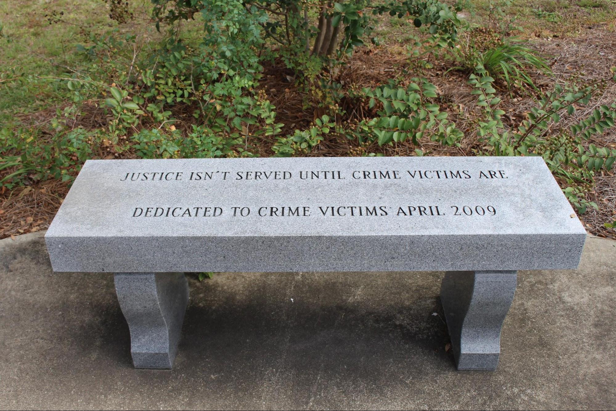 concrete bench that reads “Justice isn’t served until crime victims are.”