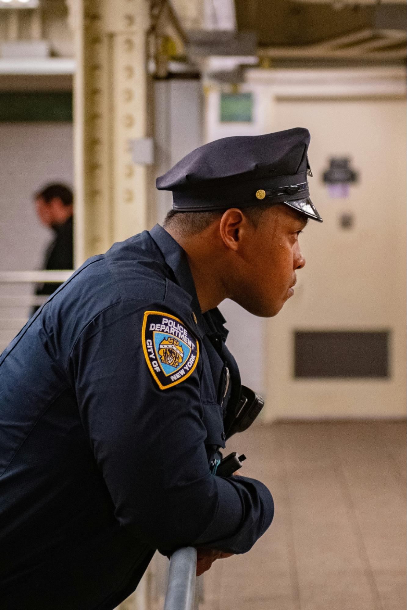 a police officer looks into the distance in a quiet moment.