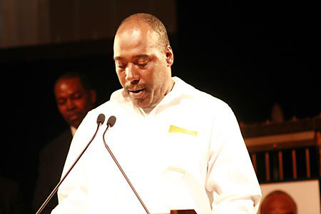 Earl Washington speaking into a microphone.