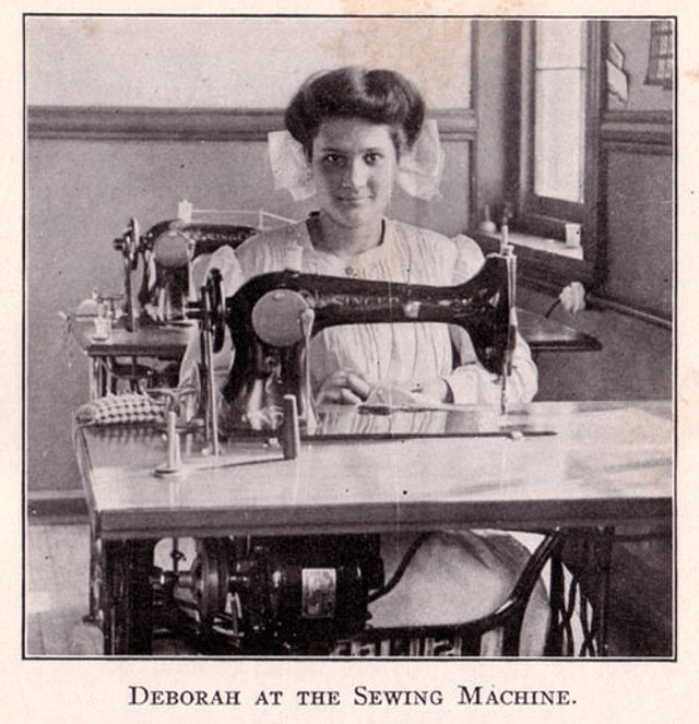 A photograph of Deborah Kallikak pictured at a sewing machine in the New Jersey Home for the Education and Care of Feebleminded Children