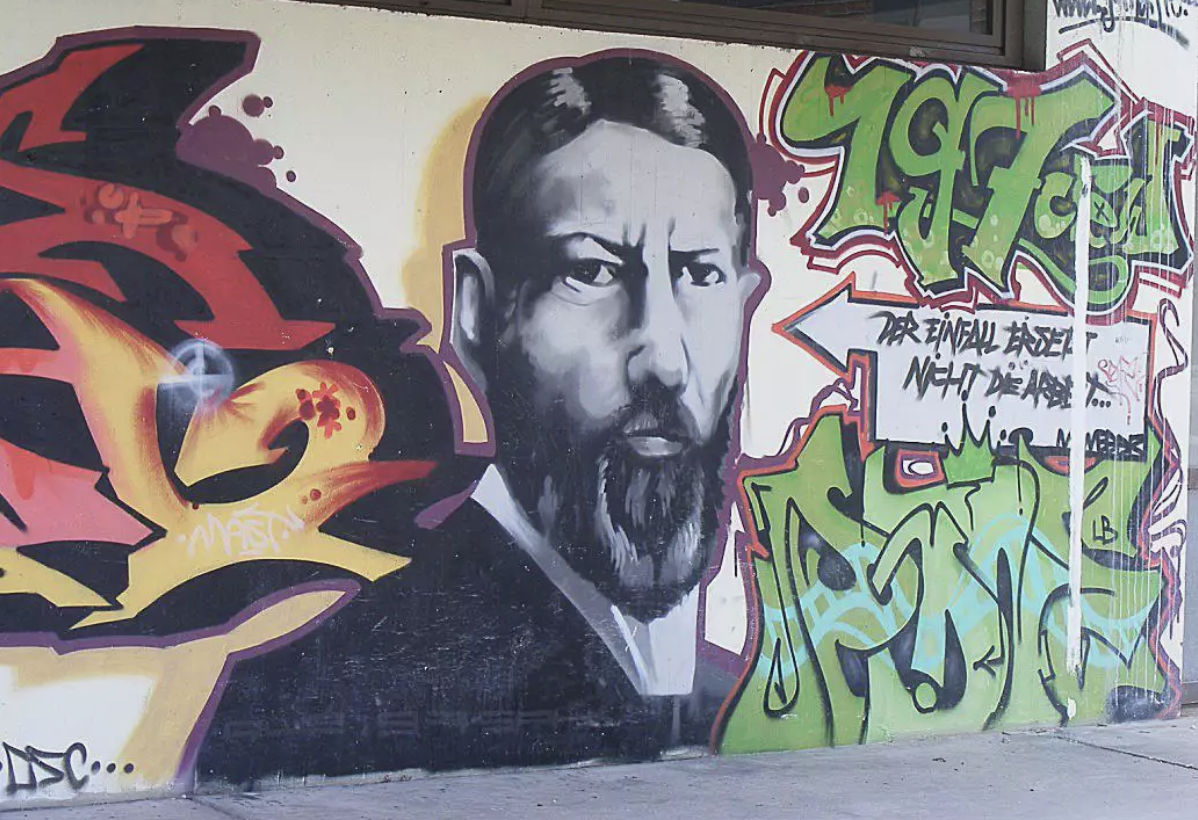 a mural of Max Weber with graffiti lettering,