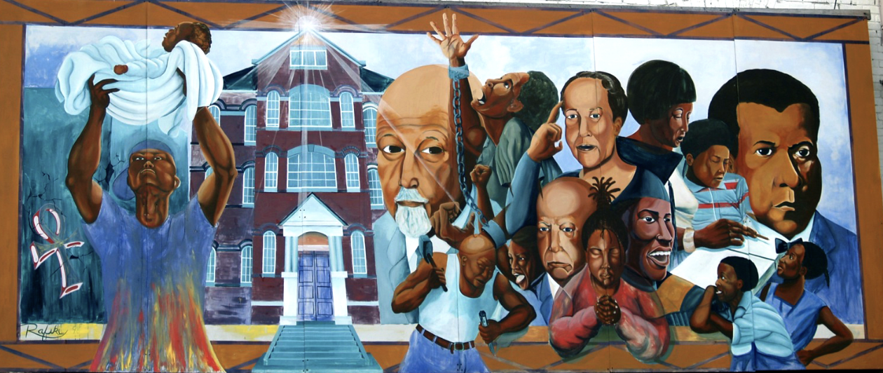 Colorful painted mural depicting people and events related to the emergence of the DC Public School system and the debate over liberal verse industrial education.