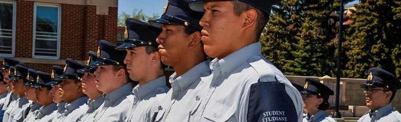 photo of a line of young men in.student police uniforms