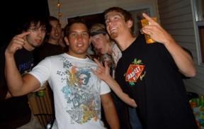 A group of teen males of various backgrounds gesture towards camera, presumably drinking alcohol