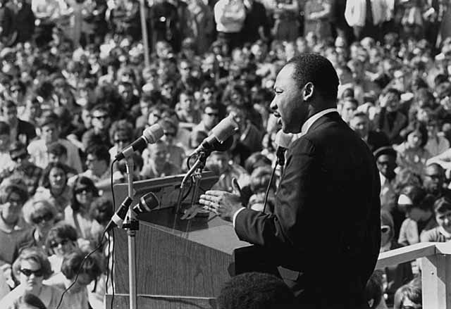 Dr. Martin Luther King, Jr. delivers a speech to a packed crowd
