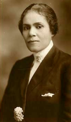 Black and white photo of Georgia Ann Robinson wearing a fancy suit and her hair pulled back in a bun