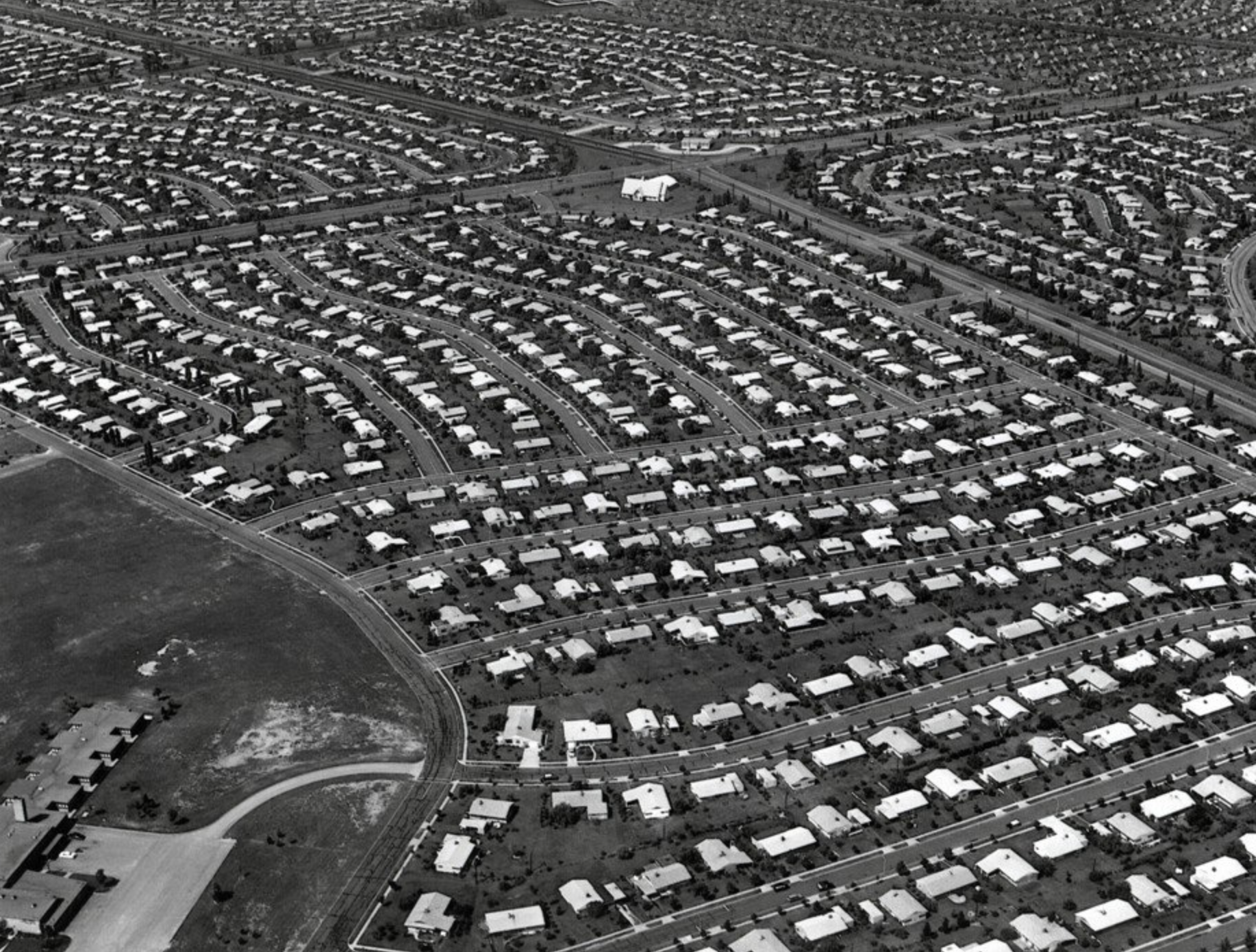 A black and white aerial view of Levittown, Pennsylvania in the 1959s, showing organized neighborhoods.