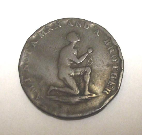 A coin with the inscription Am I not a man and a brother?