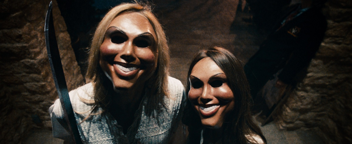 Close up photo from a doorbell camera of two armed and creepily-masked assailants from the film The Purge