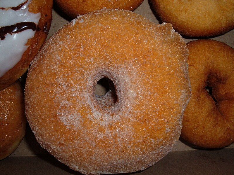 A donut covered in sugar granules.