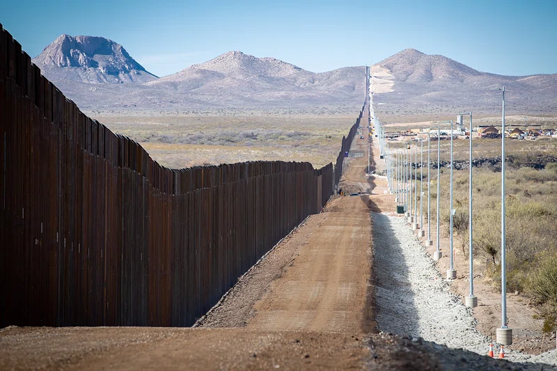 Long stretch of border fence spanning the desert