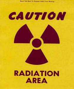 sign that says caution radiation area with radiation symbol