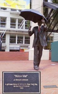 sculpture of man with umbrella