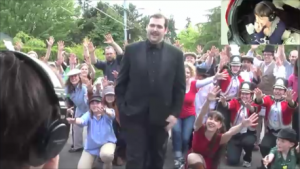 Isaac stepping in front of the crowd of people in the street