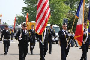 veterans in a parade with flags