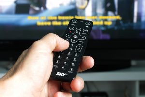 hand holding TV remote control